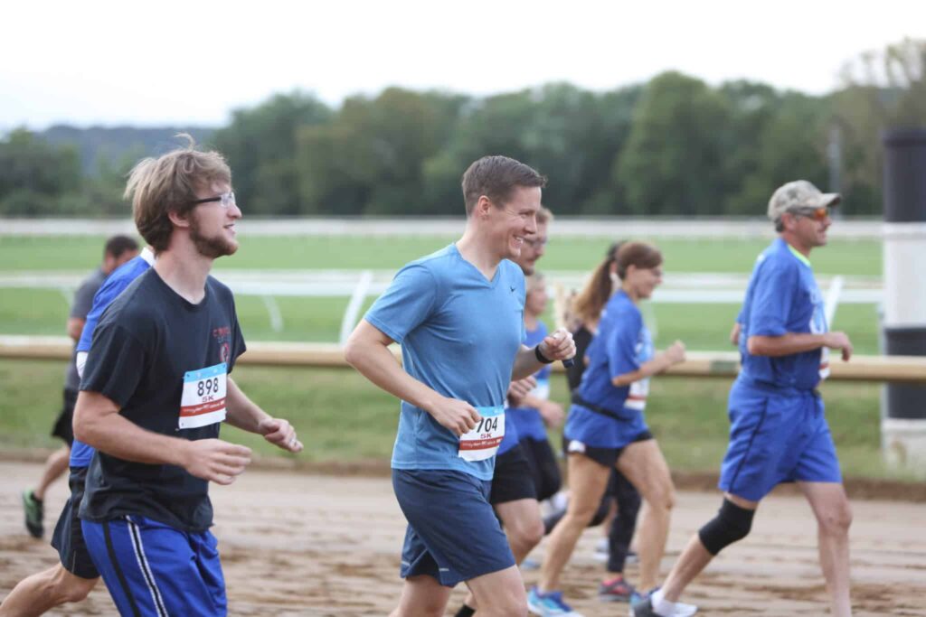 Runners at the Gentlemen Stakes 5K on a racetrack