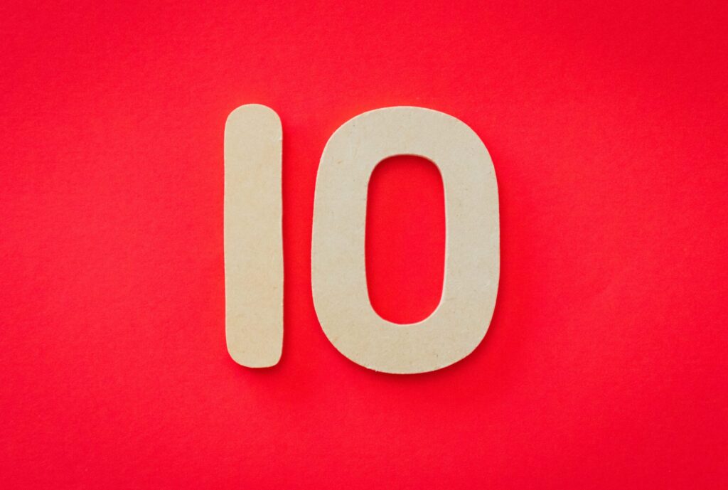 Number 10 in cream block numerals on a red background
