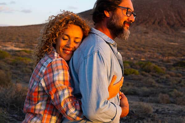 Affectionate couple embracing outdoors at sunset