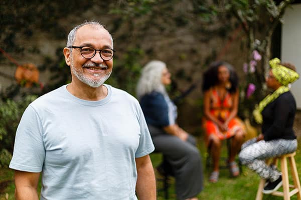 Smiling middle-aged man with friends in the background