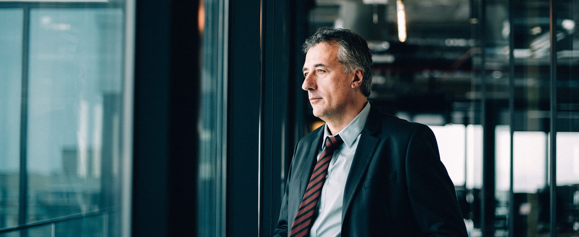 Businessman in a suit looking out a window