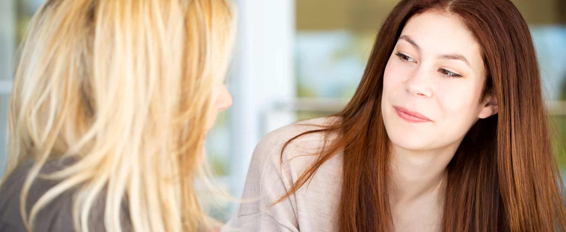 Two women talking face to face